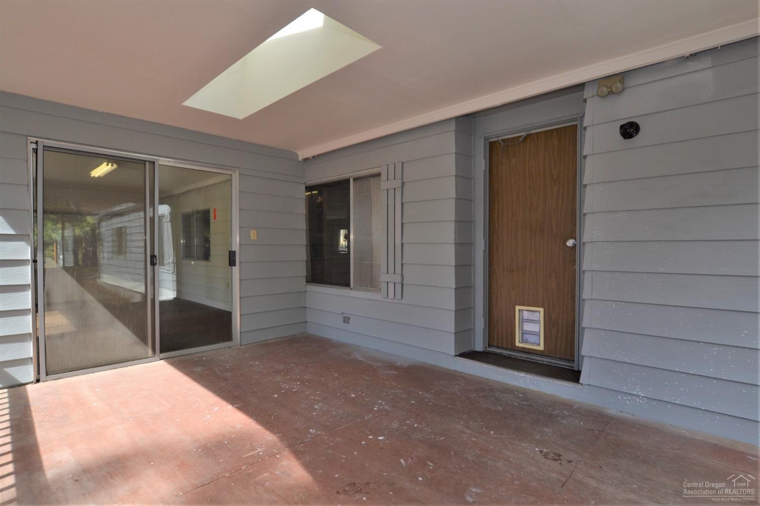 60176 Agate Road Bend, OR 97702 - Photo 3 of 21 a bedroom with a bed and a large window