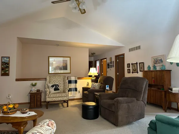 a front view of house with yard and trees in the background