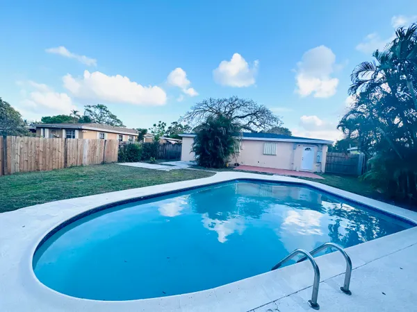 a view of a swimming pool with a yard