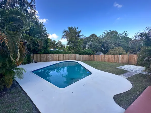 a view of a swimming pool with a yard