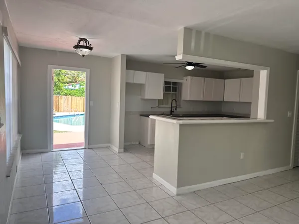 a kitchen with kitchen island granite countertop a stove a sink and a refrigerator