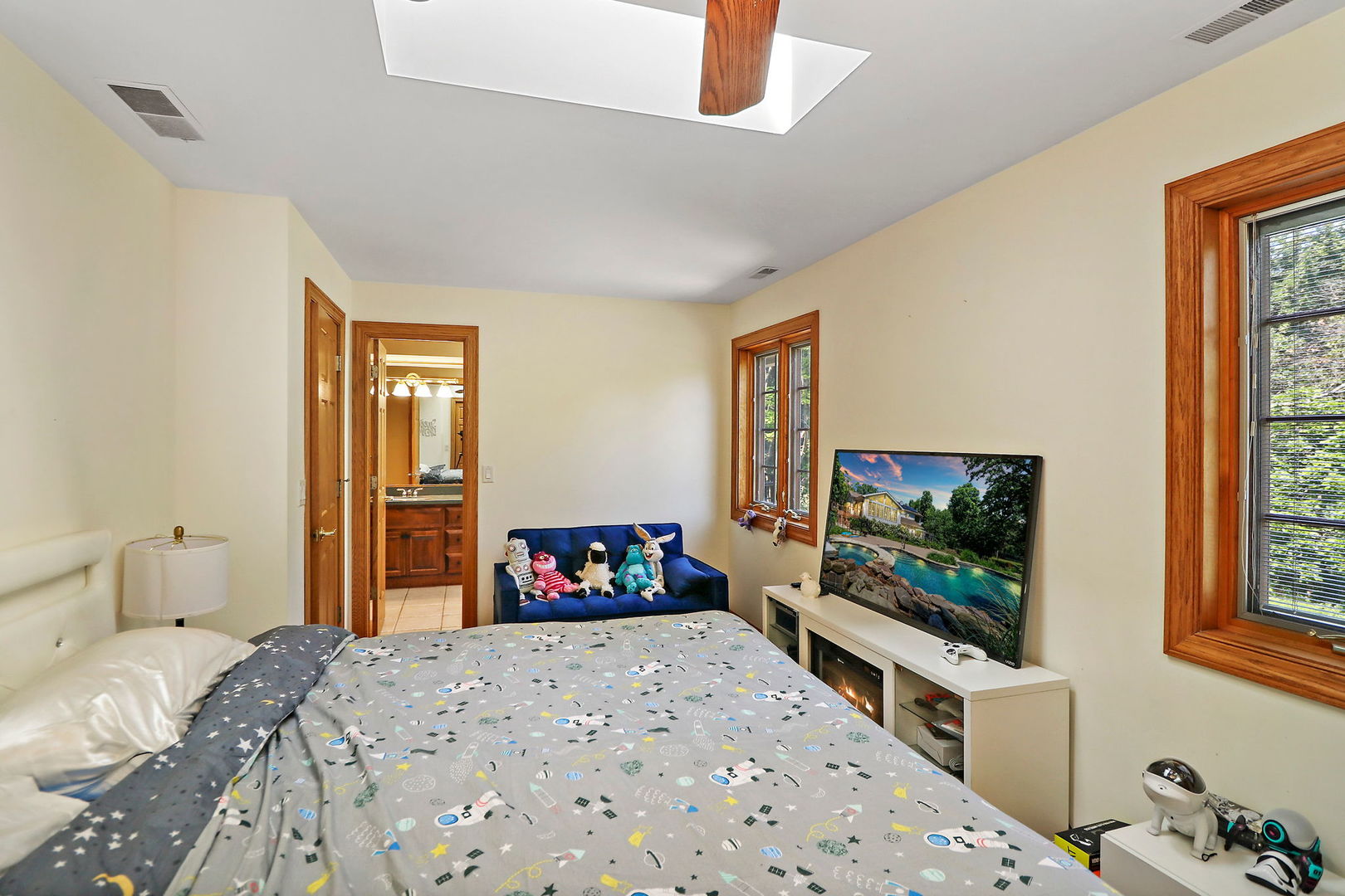 4602 Sunnyside Road Woodstock, IL 60098 - Photo 19 of 73 a bedroom with a bed and a flat screen tv