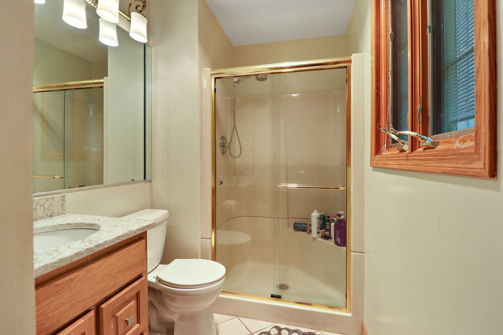 4602 Sunnyside Road Woodstock, IL 60098 - Photo 31 of 73 a bathroom with a granite countertop toilet sink and shower