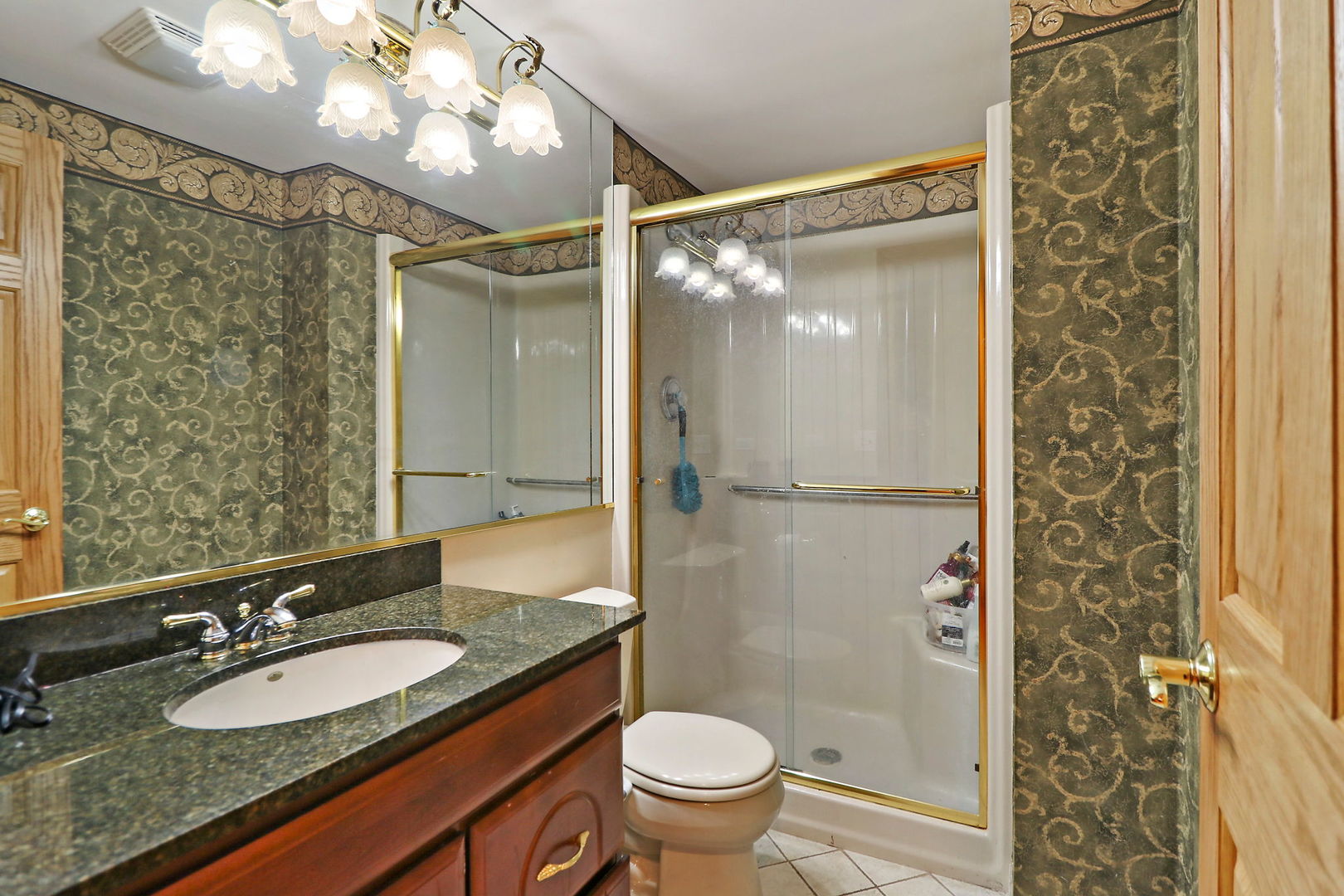 4602 Sunnyside Road Woodstock, IL 60098 - Photo 37 of 73 a bathroom with a granite countertop sink toilet and shower