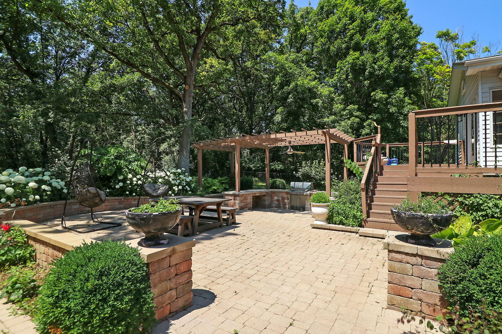 4602 Sunnyside Road Woodstock, IL 60098 - Photo 43 of 73 a view of a patio with table and chairs potted plants and large tree
