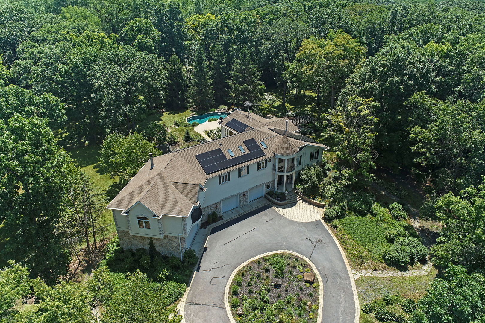 4602 Sunnyside Road Woodstock, IL 60098 - Photo 59 of 73 an aerial view of a house with a yard and large trees