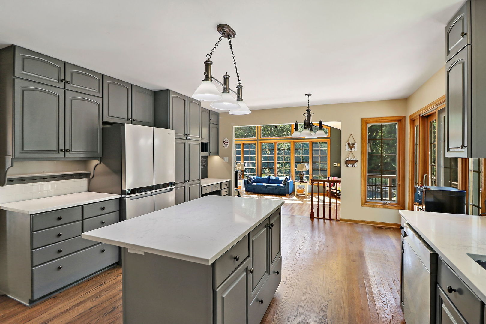 4602 Sunnyside Road Woodstock, IL 60098 - Photo 7 of 73 a kitchen with a refrigerator a sink dishwasher and white cabinets with wooden floor