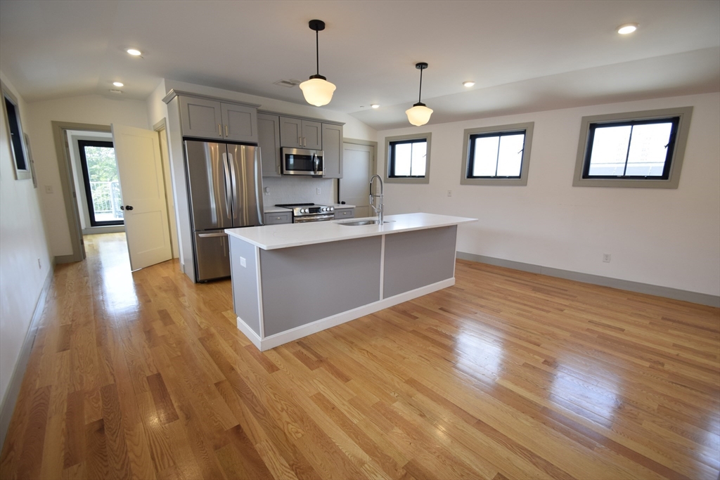 15 Maywood Street, Unit 4 Boston, MA 02119 - Photo 1 of 14 a view of kitchen with sink microwave and refrigerator