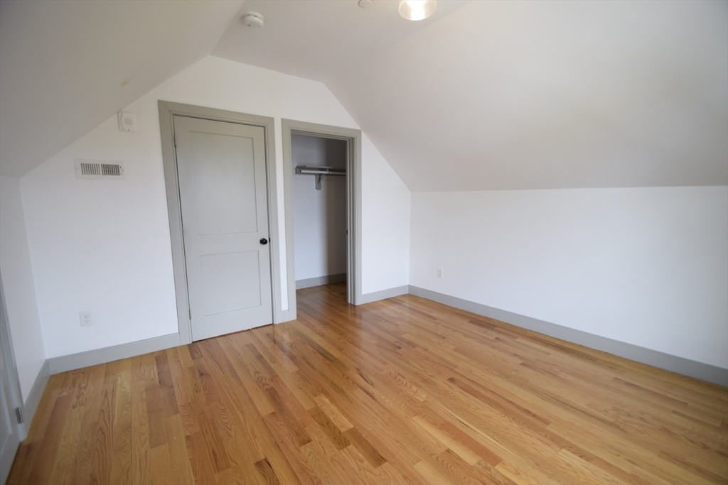 15 Maywood Street, Unit 4 Boston, MA 02119 - Photo 14 of 14 wooden floor in an empty room