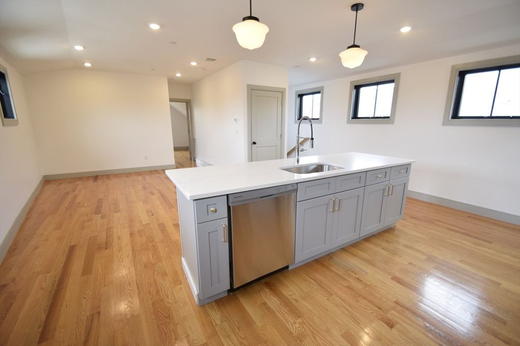 15 Maywood Street, Unit 4 Boston, MA 02119 - Photo 2 of 14 a kitchen with a sink and wooden floor