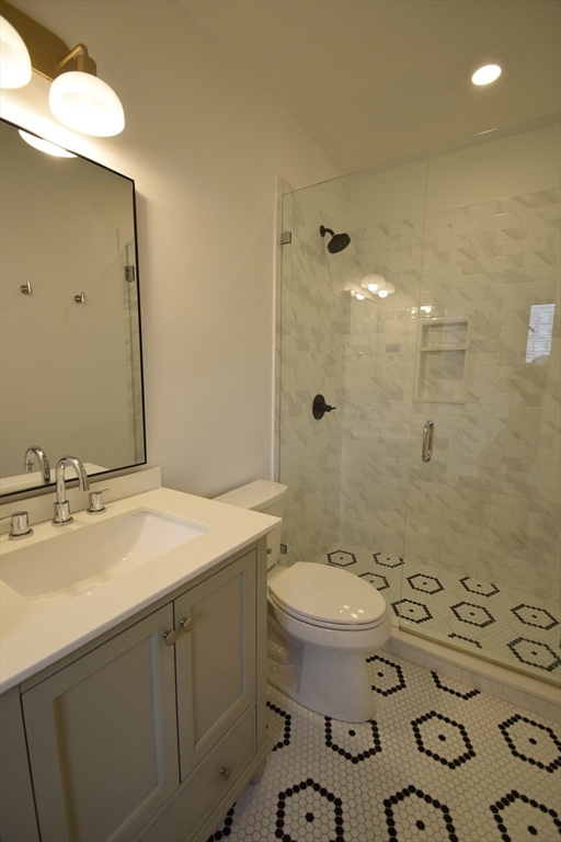 15 Maywood Street, Unit 4 Boston, MA 02119 - Photo 8 of 14 a bathroom with a sink toilet and shower