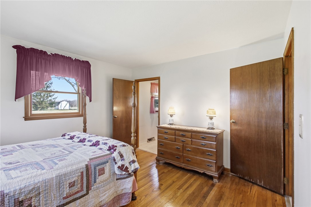 6718 Old Columbus Road South Vienna, OH 45369 - Photo 17 of 33 This cozy bedroom features hardwood floors and a bright window.