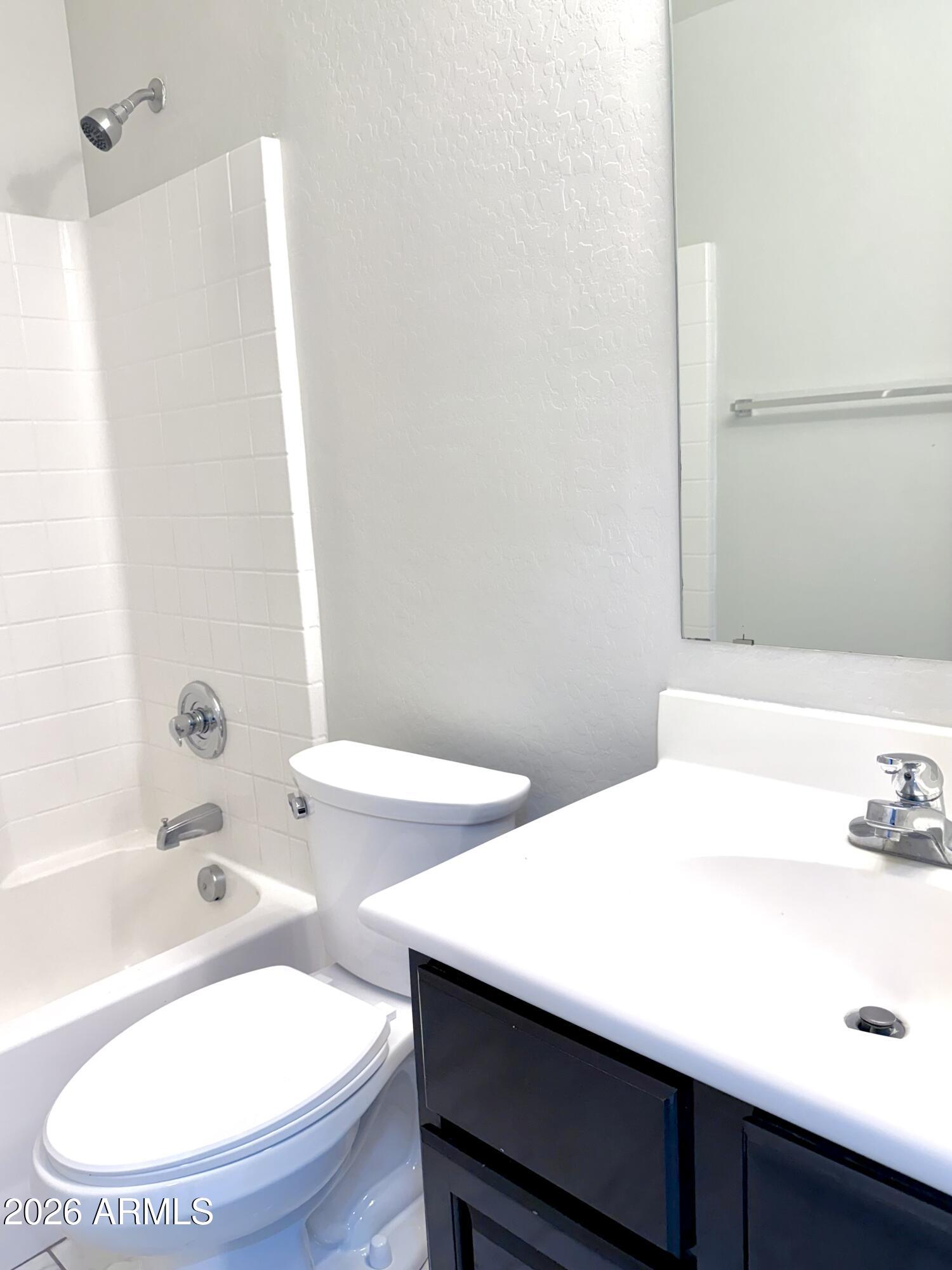 2326 West Gaby Road Phoenix, AZ 85041 - Photo 33 of 75 a bathroom with a sink and a mirror