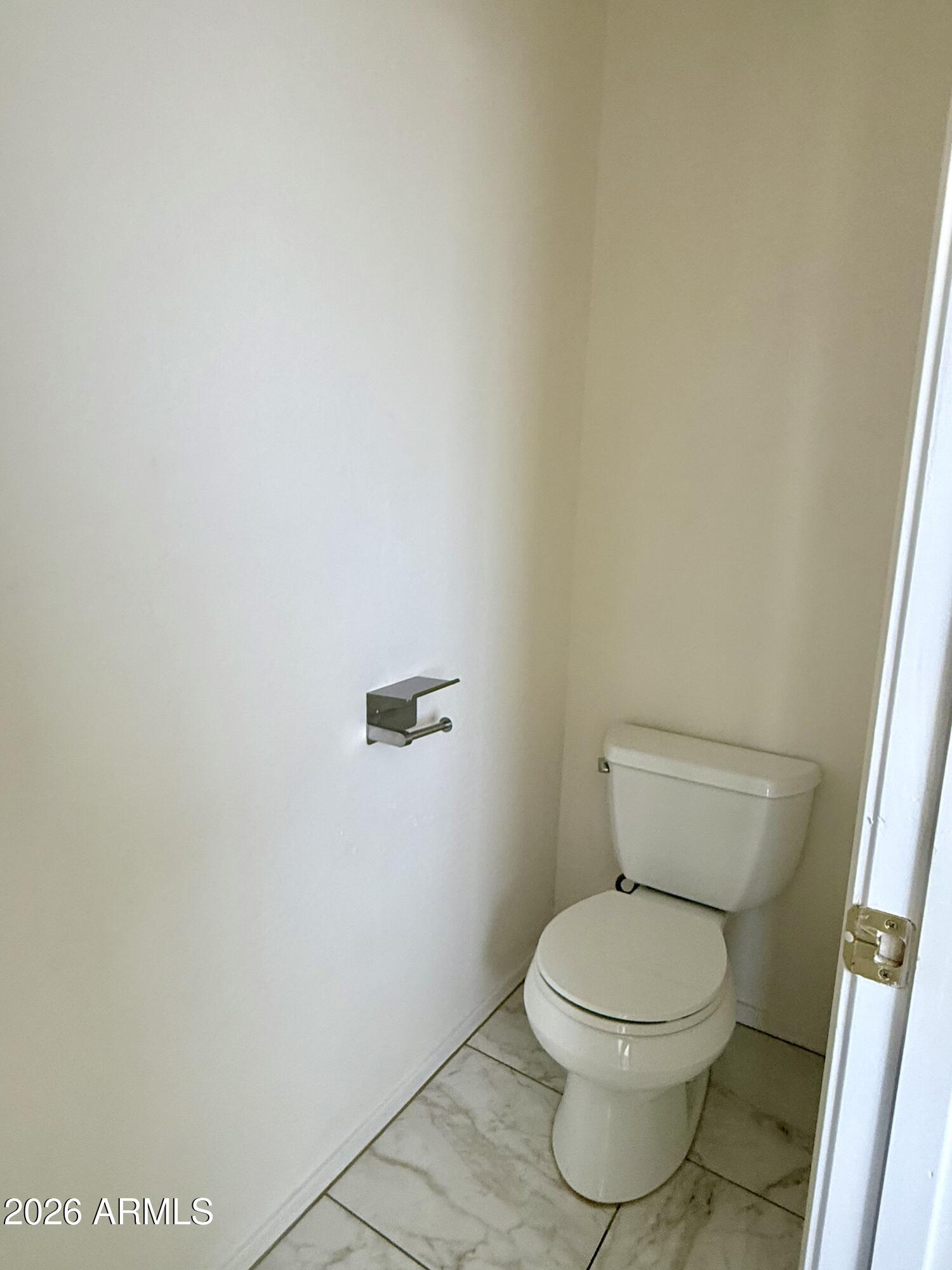 2326 West Gaby Road Phoenix, AZ 85041 - Photo 39 of 75 a white toilet sitting next to a shower