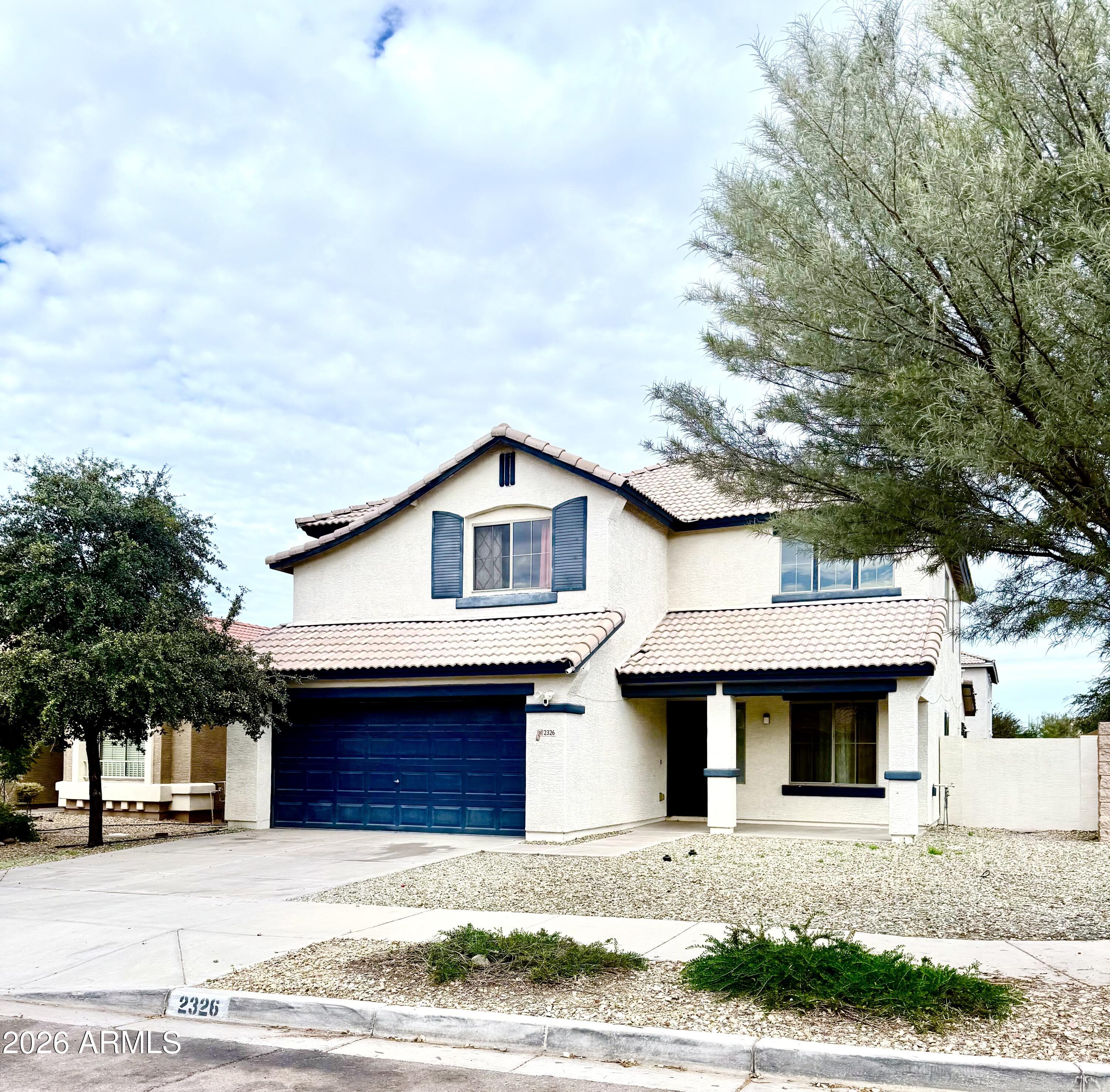 2326 West Gaby Road Phoenix, AZ 85041 - Photo 4 of 75 a front view of a house with a yard and garage