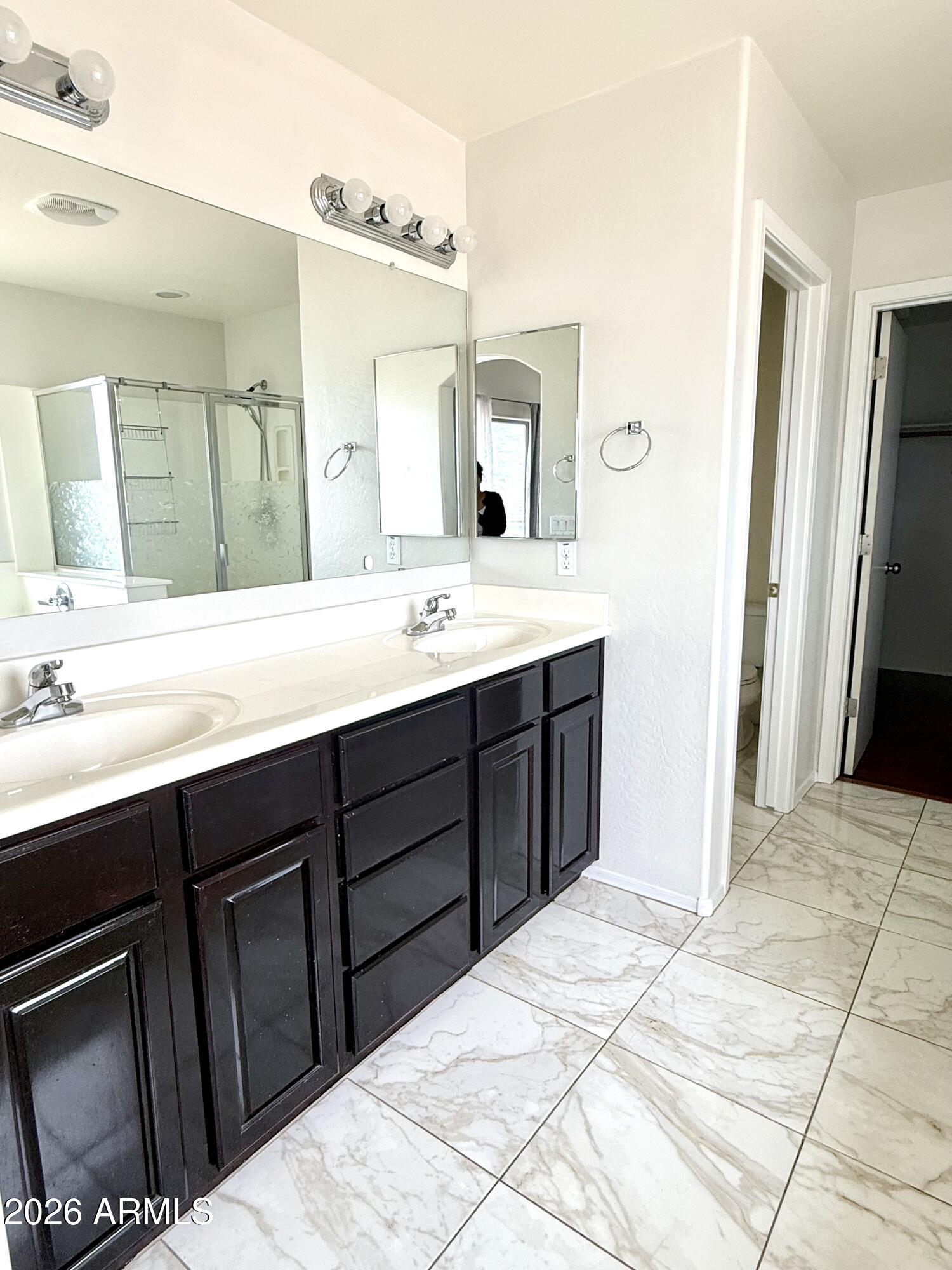 2326 West Gaby Road Phoenix, AZ 85041 - Photo 41 of 75 a bathroom with a sink and a mirror