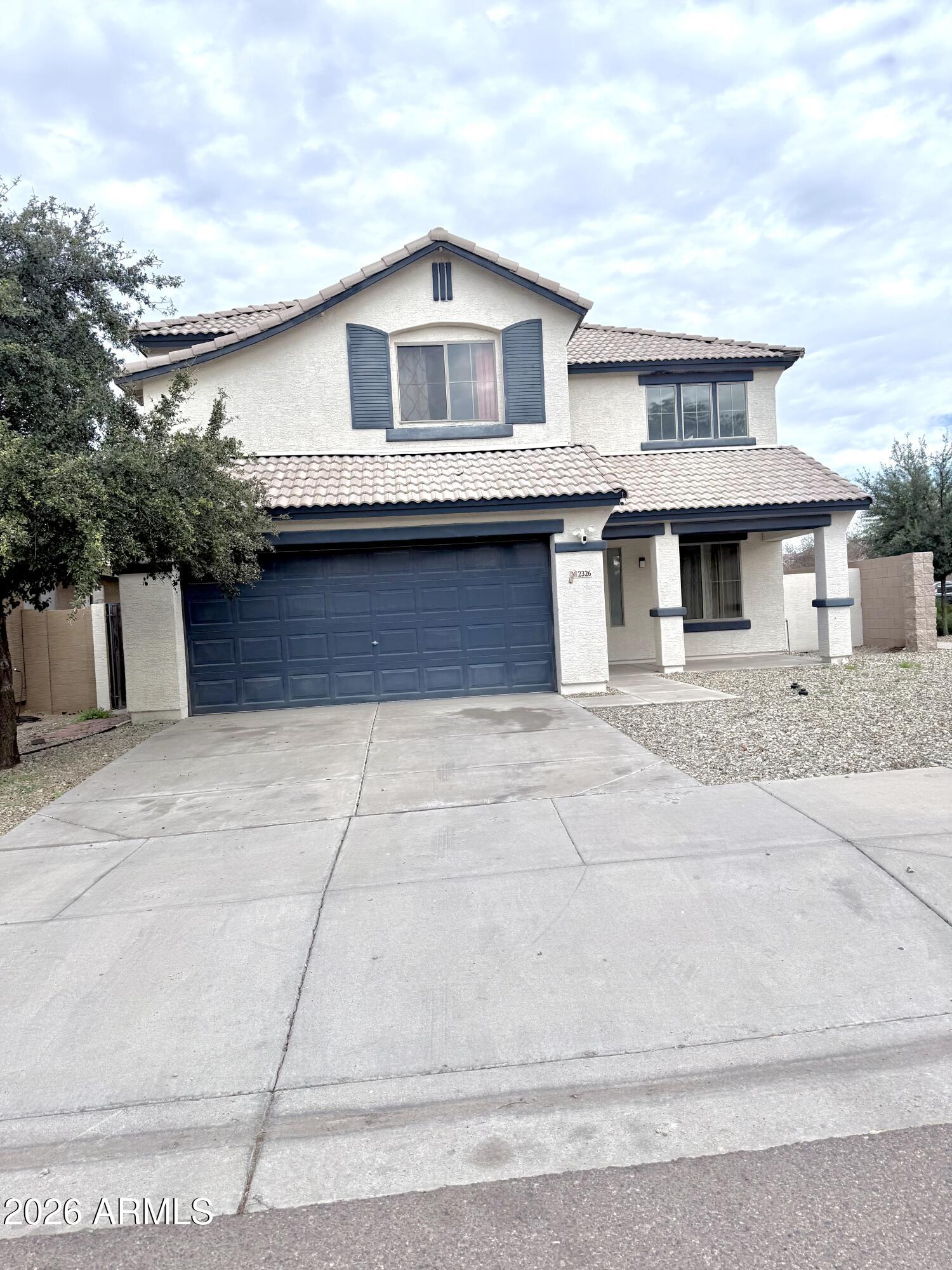 2326 West Gaby Road Phoenix, AZ 85041 - Photo 5 of 75 a front view of a house with a garage