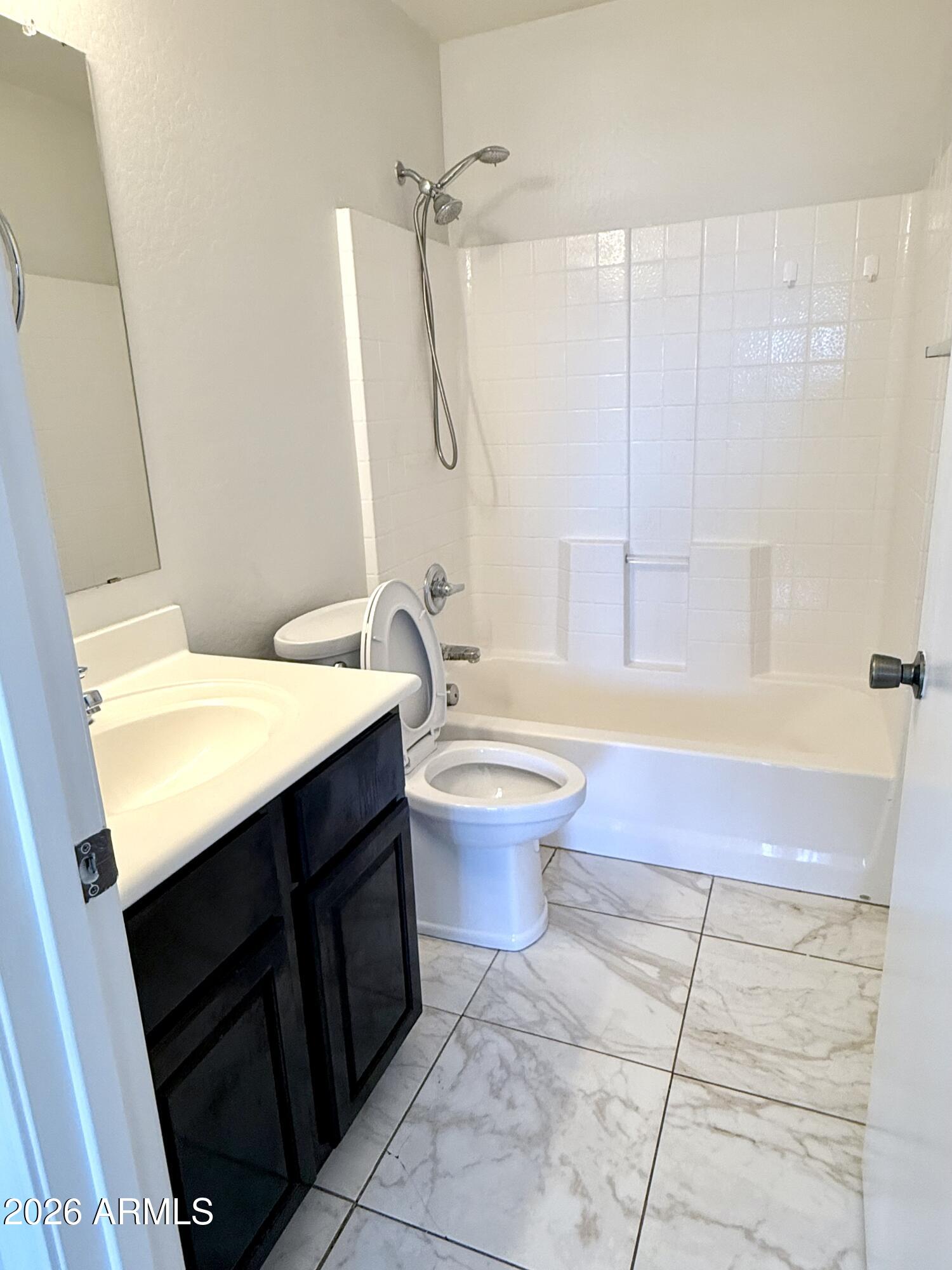 2326 West Gaby Road Phoenix, AZ 85041 - Photo 53 of 75 a bathroom with a sink a toilet and shower