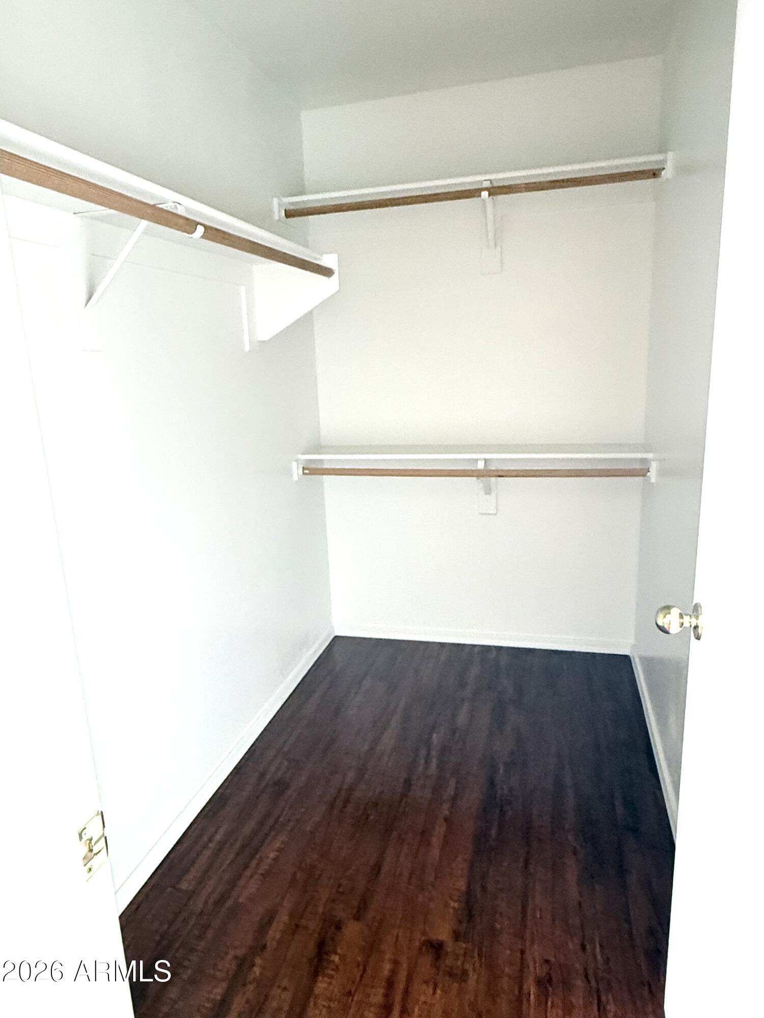 2326 West Gaby Road Phoenix, AZ 85041 - Photo 59 of 75 a view of an empty room with wooden floor