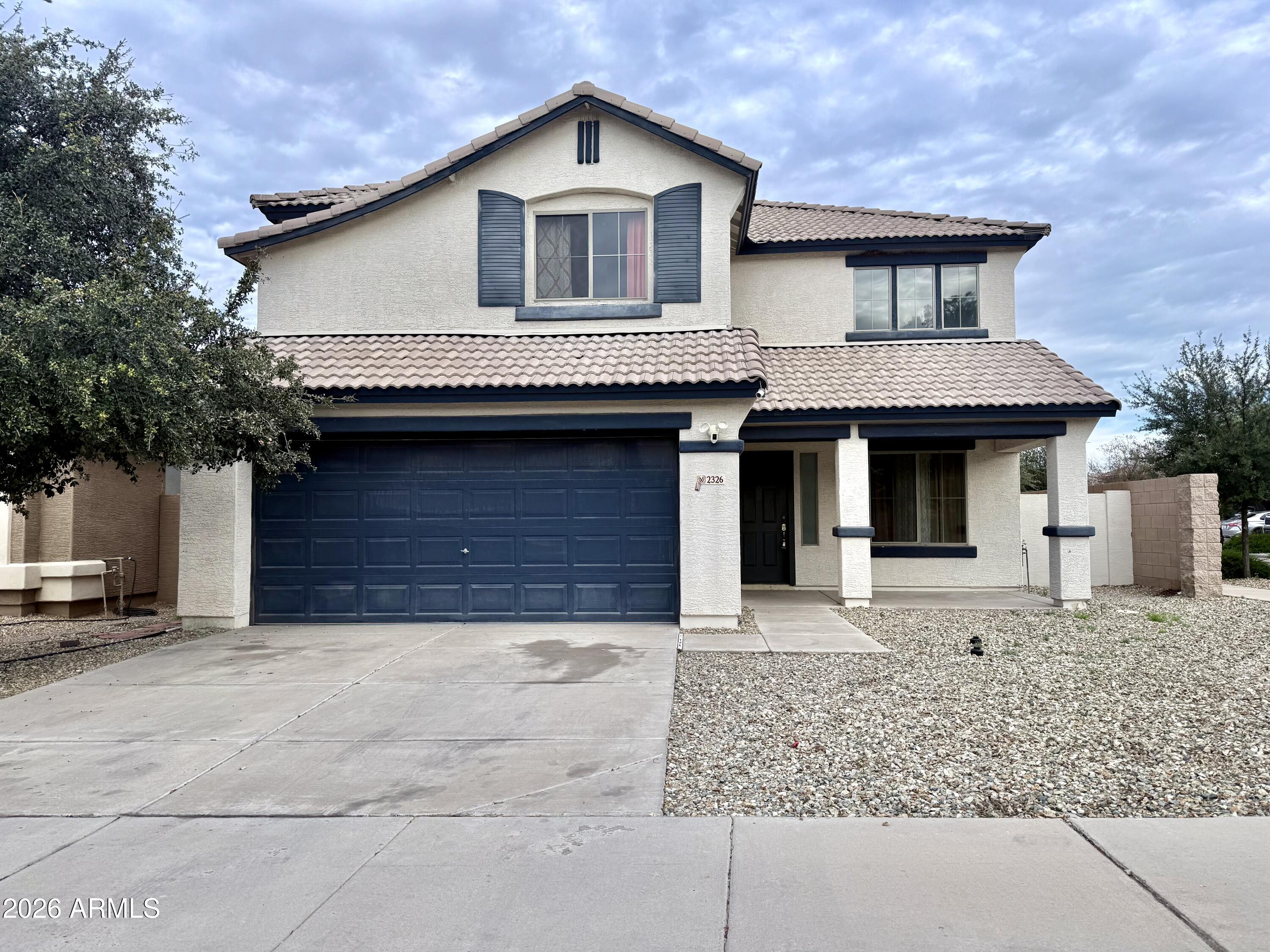 2326 West Gaby Road Phoenix, AZ 85041 - Photo 6 of 75 a front view of a house with garden