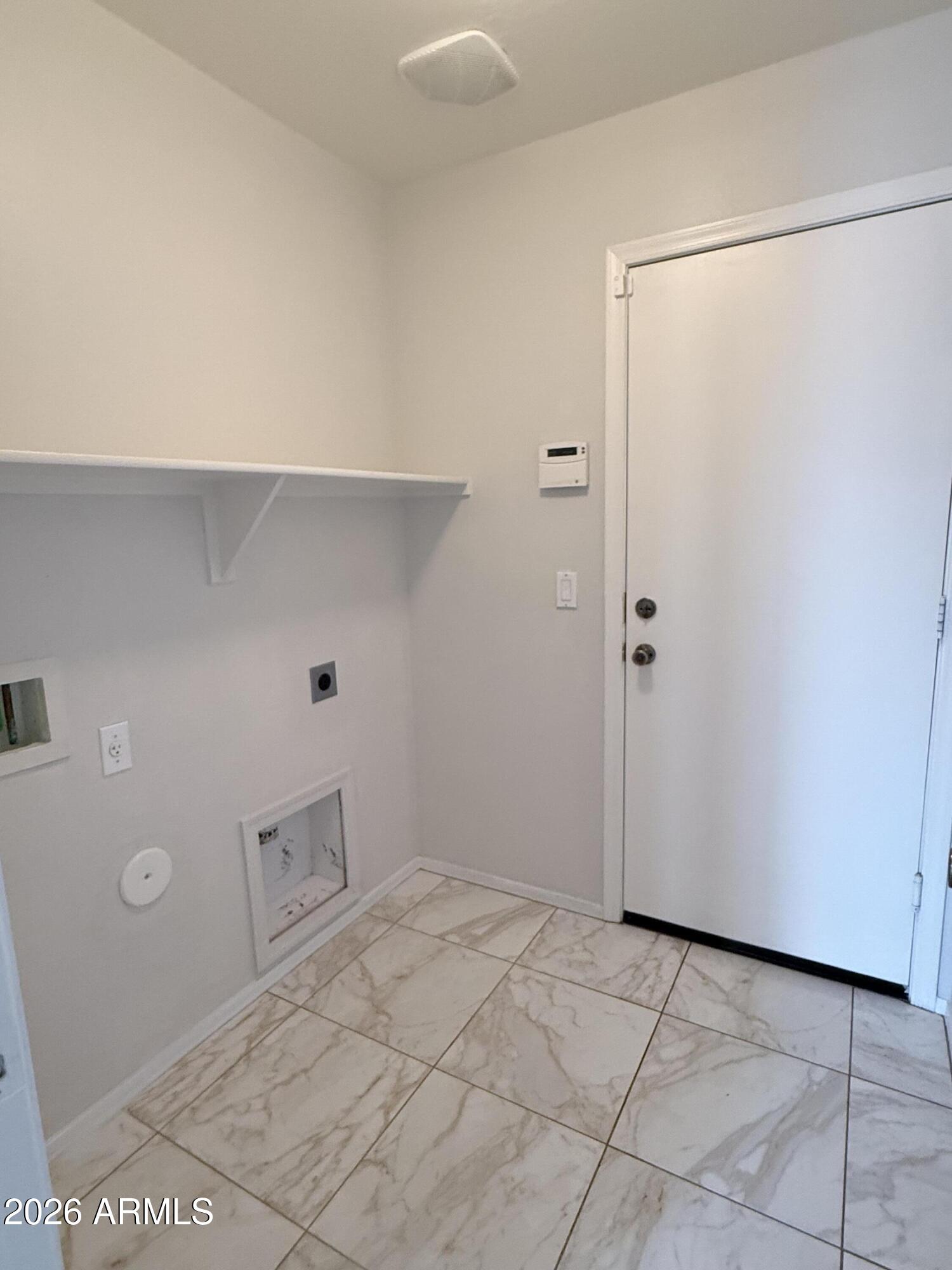 2326 West Gaby Road Phoenix, AZ 85041 - Photo 62 of 75 a view of a room with a shelf