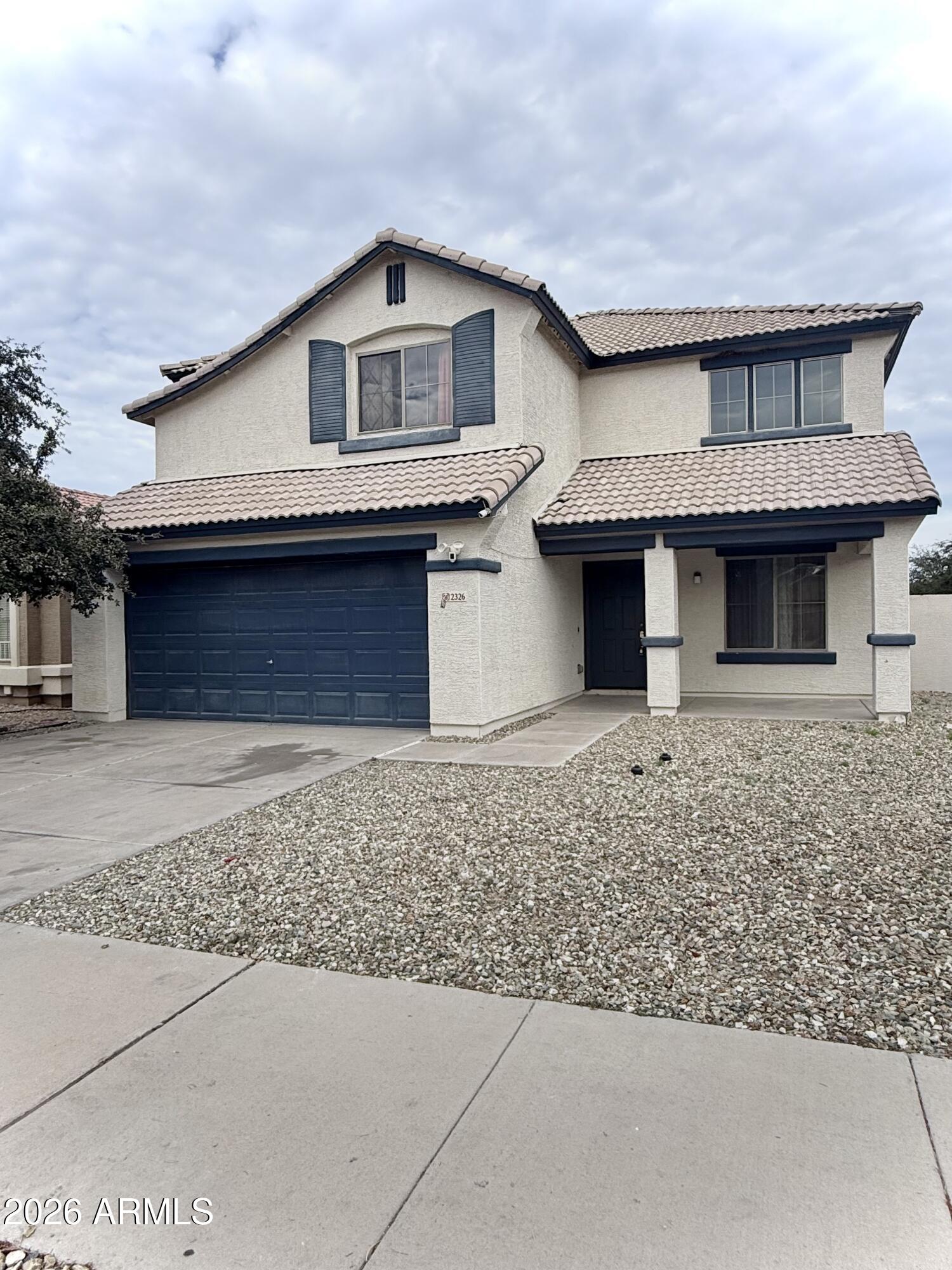 2326 West Gaby Road Phoenix, AZ 85041 - Photo 7 of 75 a front view of a house with a garden