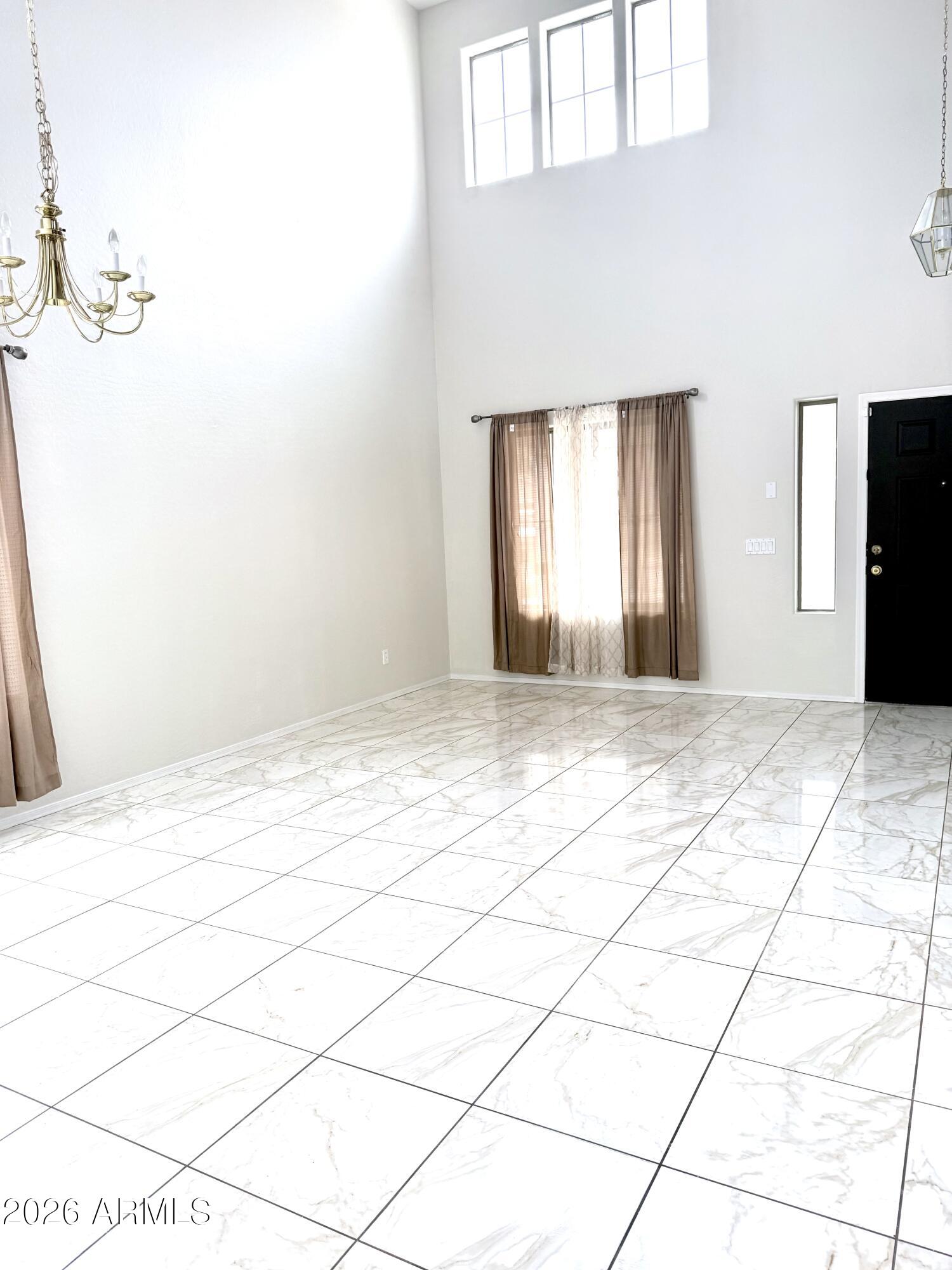 2326 West Gaby Road Phoenix, AZ 85041 - Photo 9 of 75 a view of an empty room and window