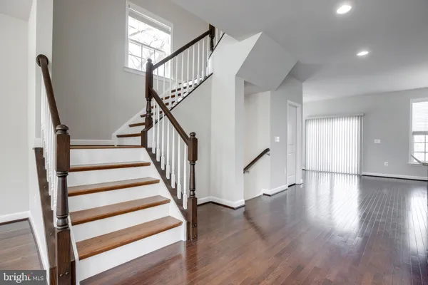 a view of entryway with wooden floor and stairs