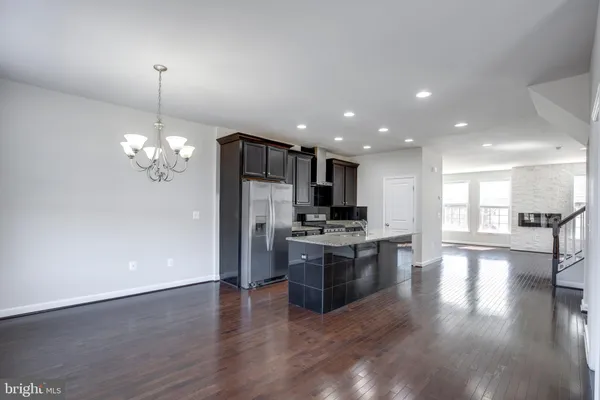 a view of kitchen with refrigerator stove and oven