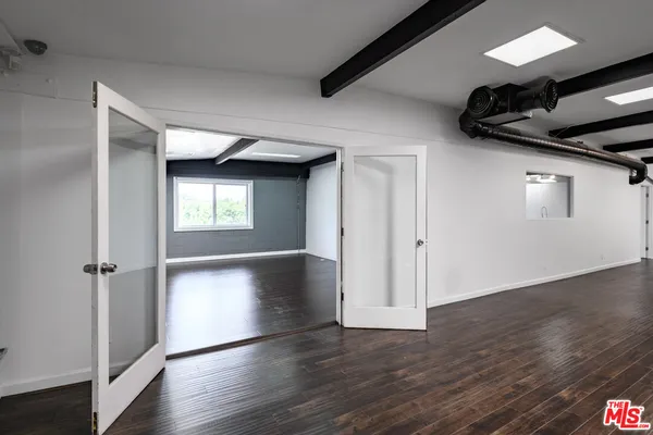 a view of hallway with wooden floor