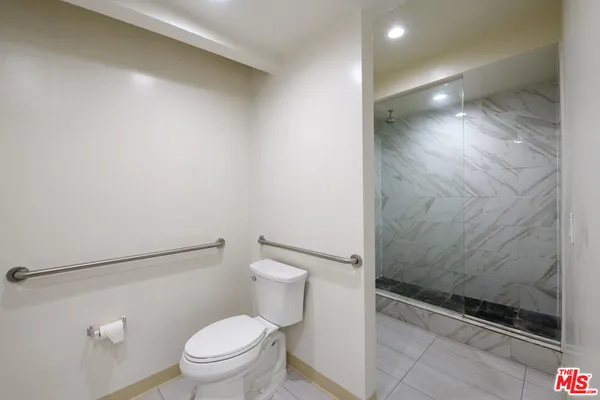 a bathroom with a toilet and a shower