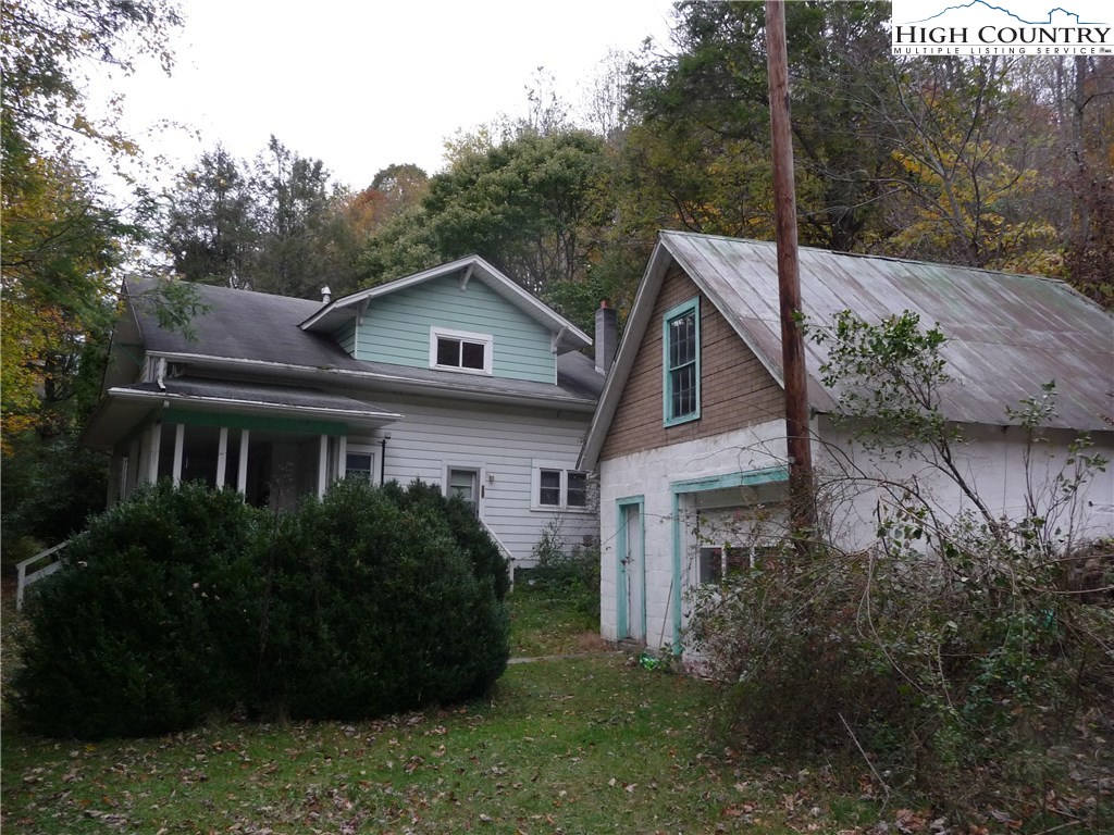 3240 Meat Camp Road Todd, NC 28684 - Photo 3 of 21 a front view of a house with a garden