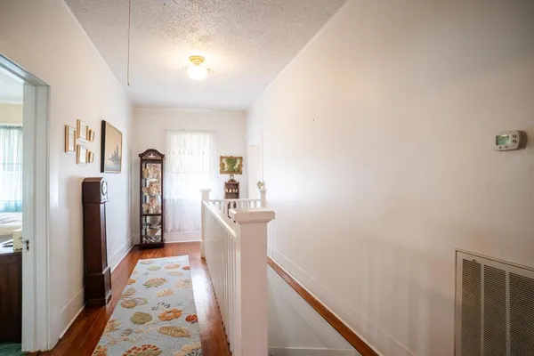 a bedroom with a bed and hallway