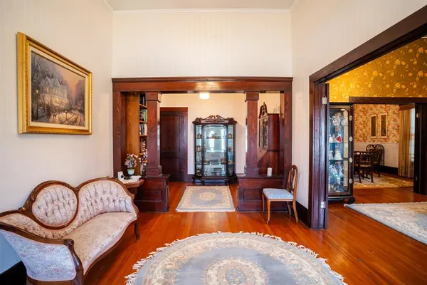 a living room with furniture a chandelier and a large window