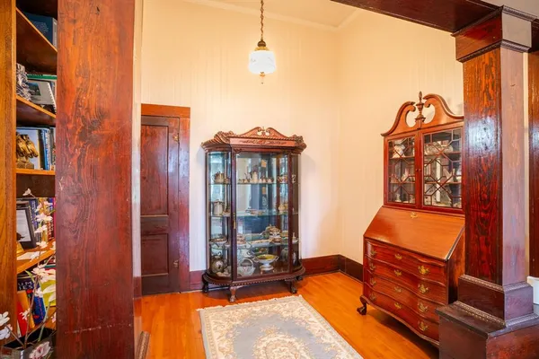 a living room filled with furniture hardwood floor and a chandelier