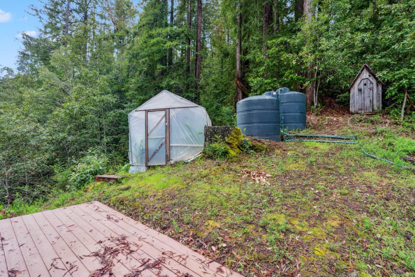805 Fanning Grde Ben Lomond, CA 95005 - Photo 38 of 60 a backyard of a house with a garden and outdoor seating