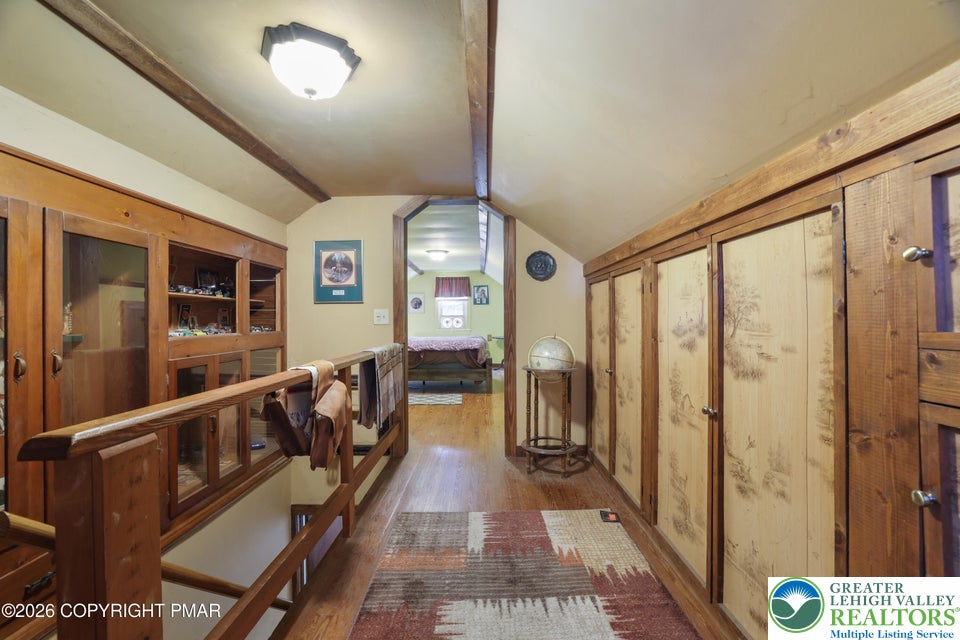 1207 Seese Hill Road Canadensis, PA 18325 - Photo 19 of 49 Rich wood built-ins and hardwood floors line this cozy upper-level hallway space.