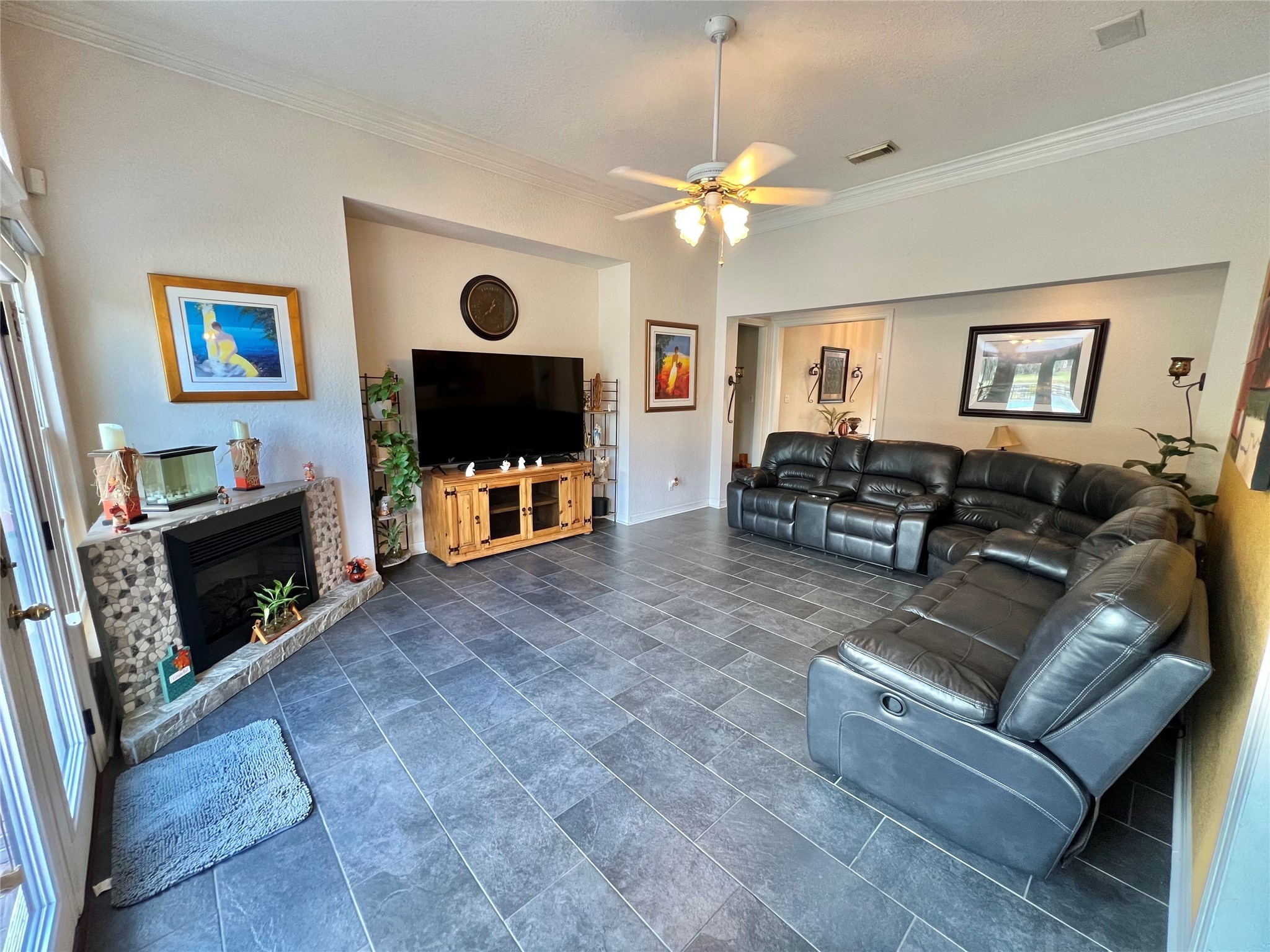 150 Cornelia Lane Angleton, TX 77515 - Photo 13 of 45 a living room with furniture a flat screen tv and a fireplace