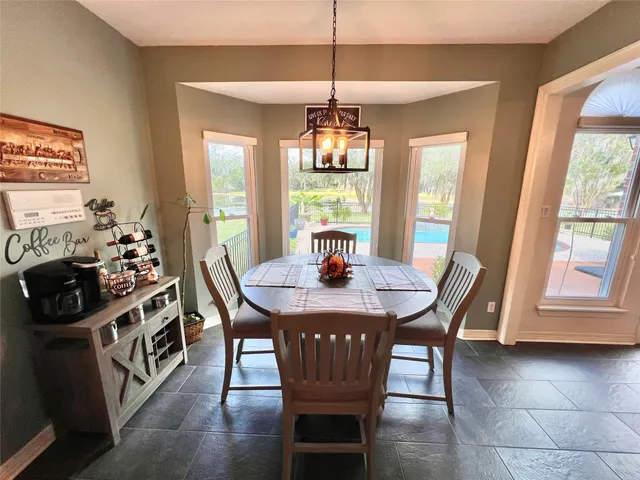 a view of a dining room with furniture wooden floor and chandelier