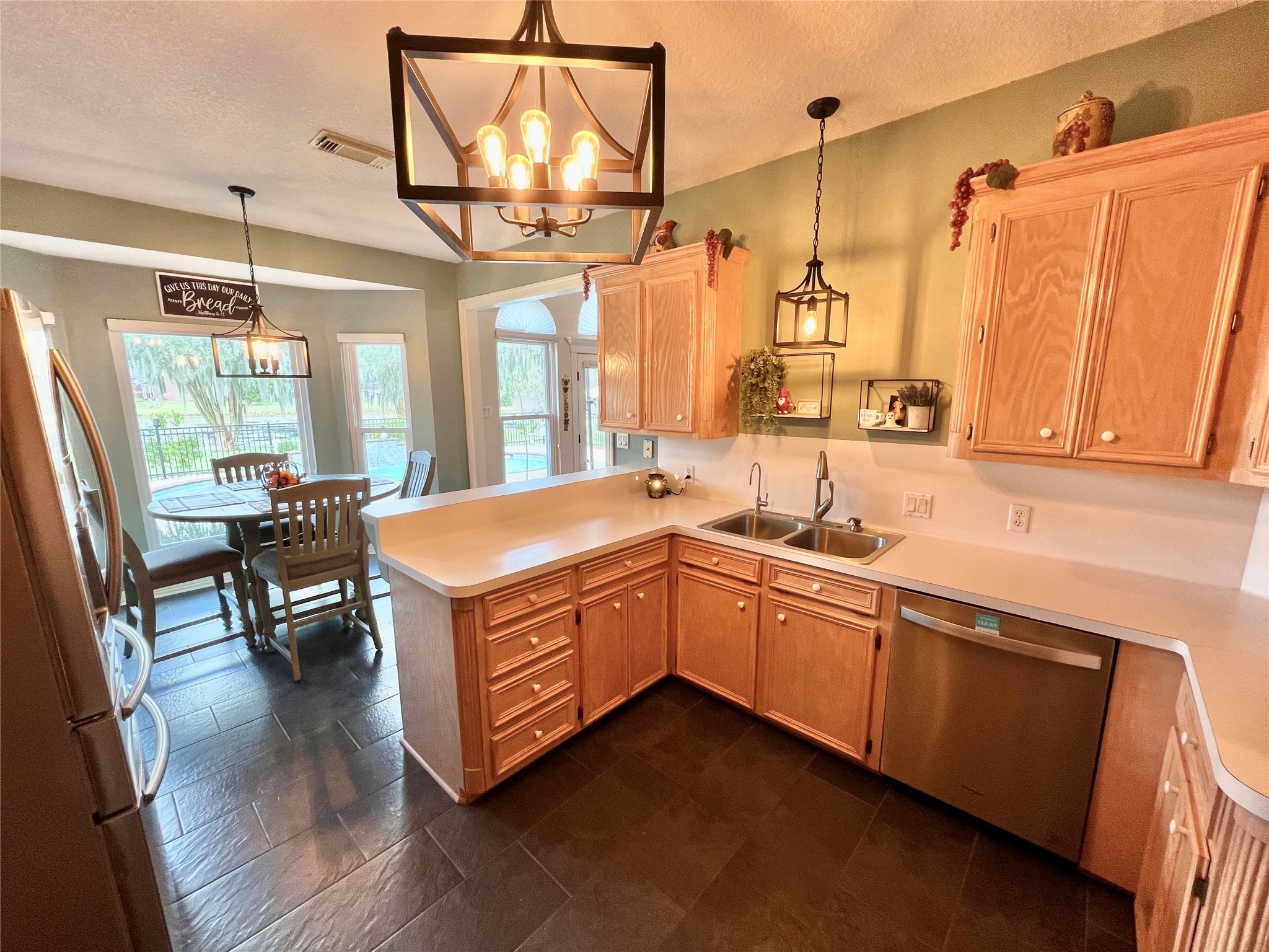 150 Cornelia Lane Angleton, TX 77515 - Photo 18 of 45 a kitchen with stainless steel appliances granite countertop a sink a stove and a wooden floors