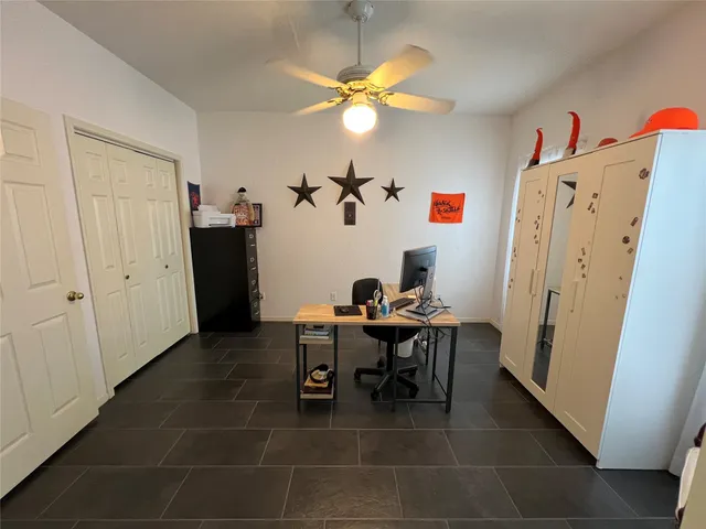 a view of a dining room with a table and chairs