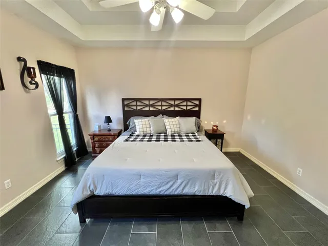 a bedroom with a bed and a mirror