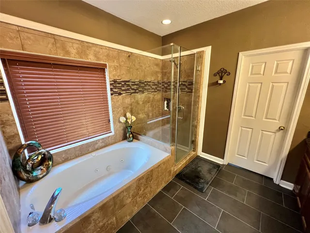 a bathroom with a tub and a shower