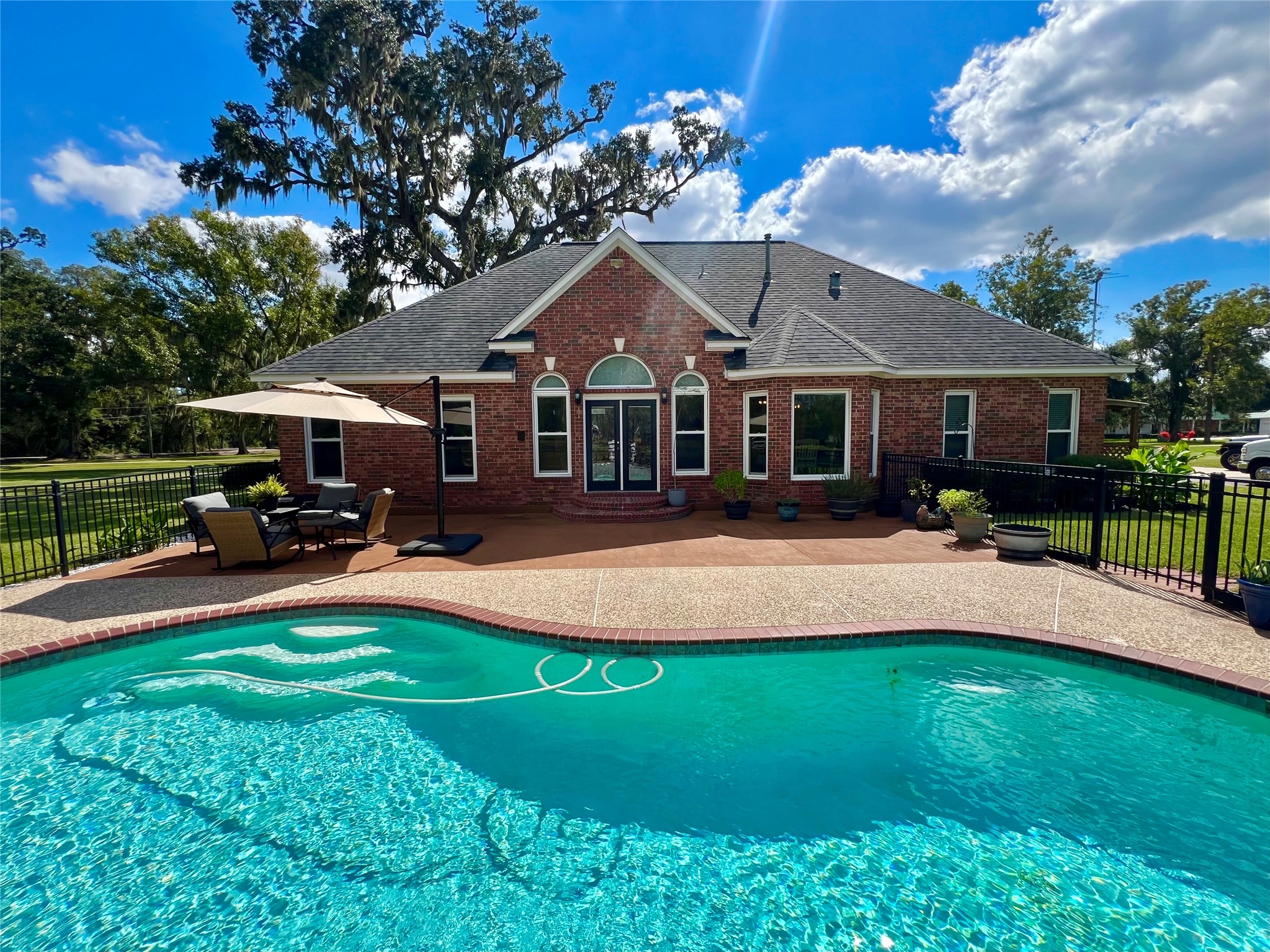 150 Cornelia Lane Angleton, TX 77515 - Photo 34 of 45 a front view of a house with a garden and swimming pool