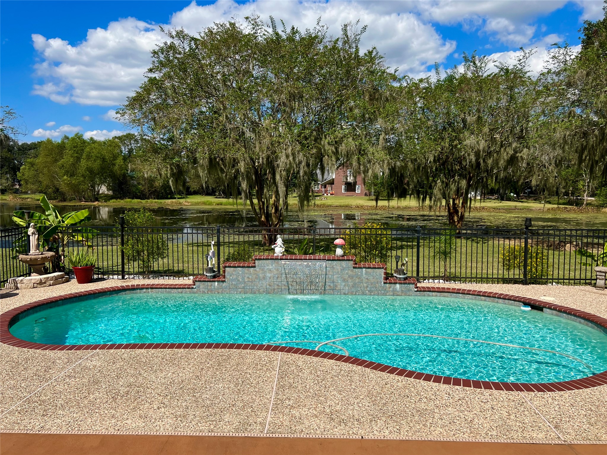 150 Cornelia Lane Angleton, TX 77515 - Photo 36 of 45 a view of a lake with a house in the background