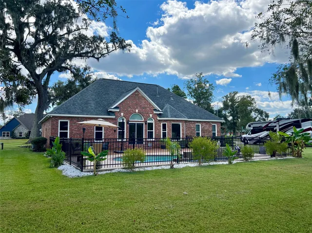 a front view of house with yard and green space