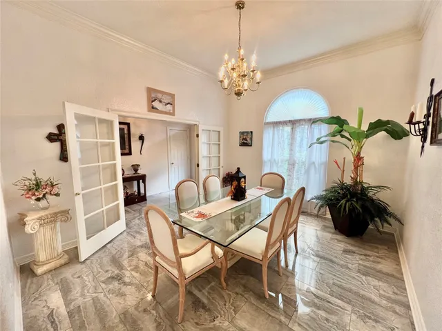 a view of a dining room with furniture and chandelier