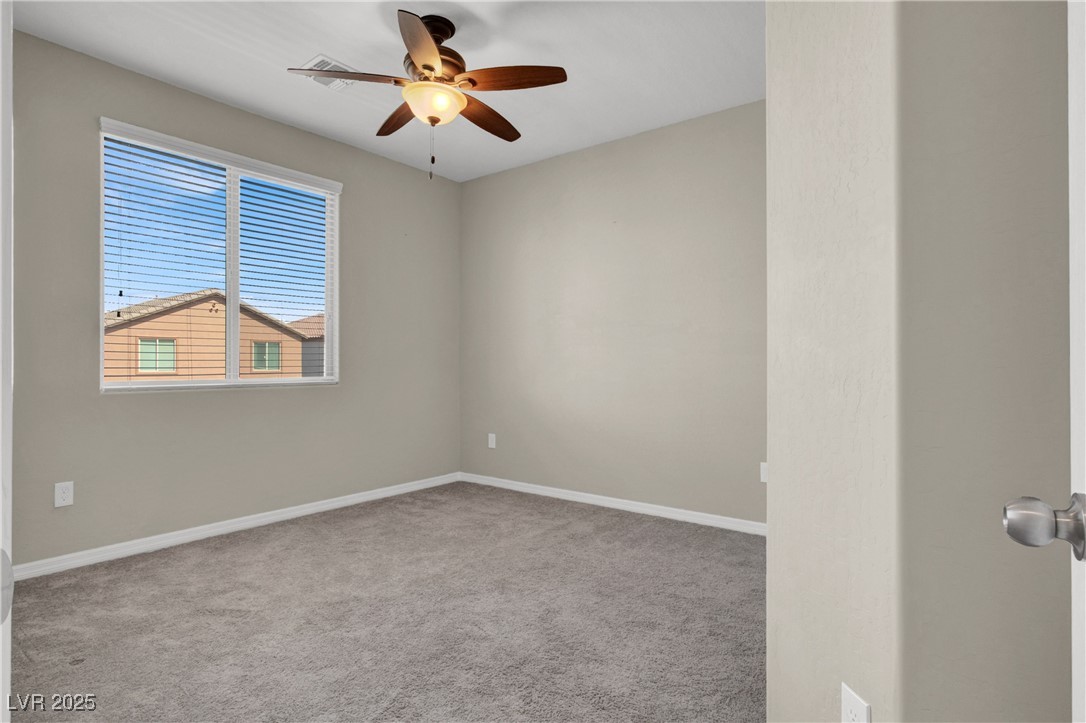 10976 Bluebell Basin Road Las Vegas, NV 89179 - Photo 35 of 40 Carpeted spare room with a ceiling fan and baseboards