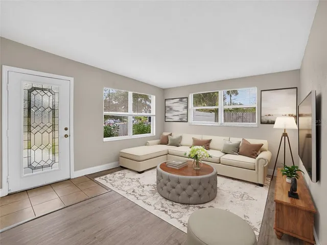a living room with furniture and a large window