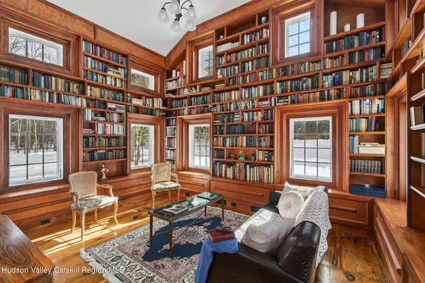 a view of a workspace with furniture and a bookshelf
